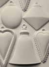 Finished castings from the IOD Bibelots 2 Mould featuring ornate charms and vintage details.