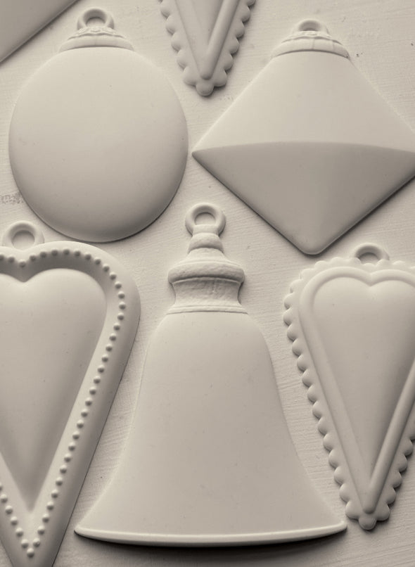 Finished castings from the IOD Bibelots 2 Mould featuring ornate charms and vintage details.