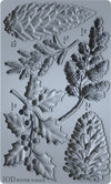 Rendered view of the IOD Winter Forage Mould showing detailed cavities of pinecones, berries, and holly leaves.