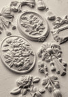 Finished castings made with the IOD Victoriana Mould showing ornate Victorian-style scrolls and embellishments.