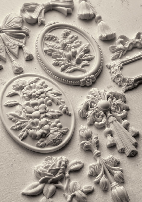 Finished castings made with the IOD Victoriana Mould showing ornate Victorian-style scrolls and embellishments.