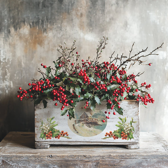 Rustic wooden planter decorated with IOD Christmas Joy Transfer snowy mill and holly design, filled with red winter berries.